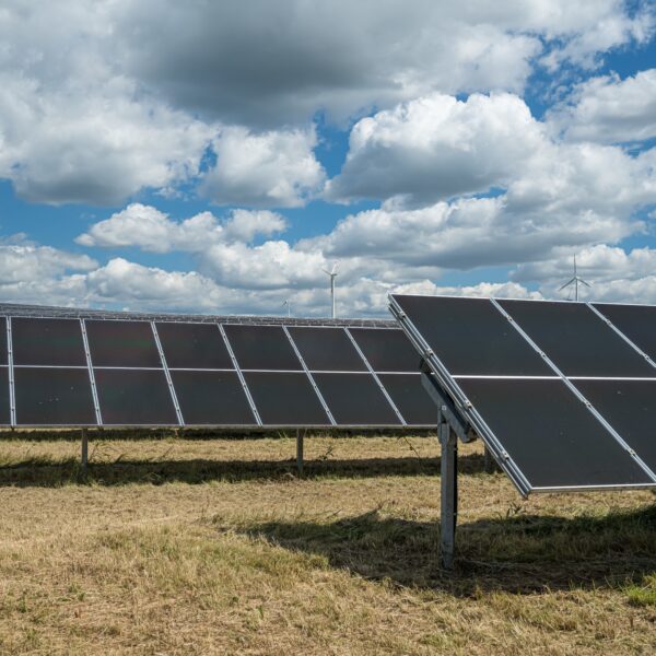 Solar panels in the grain field in the countryside under the cloudy sky The solar panels in the grain field in the countryside under the cloudy sky